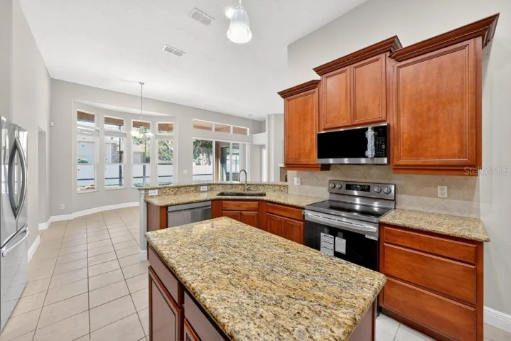 Solid Wood cabinets, New Stainless Appliances, Granite Counter Tops, Large Pantry and an Island