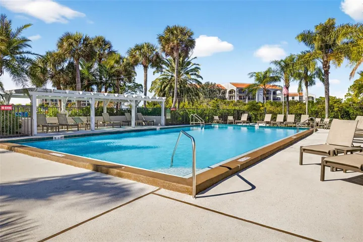 Resort-style pool surrounded by tropical landscaping. Where lazy afternoons are perfected.