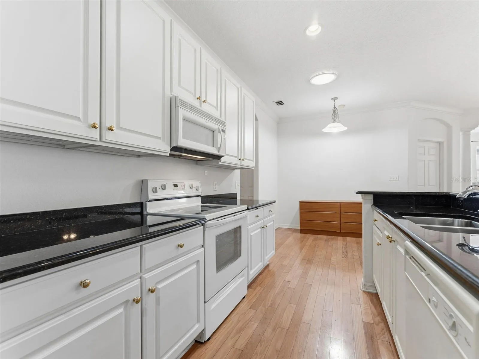 Casual dining adjacent to kitchen, solar tube adds natural light; crown molding in living areas