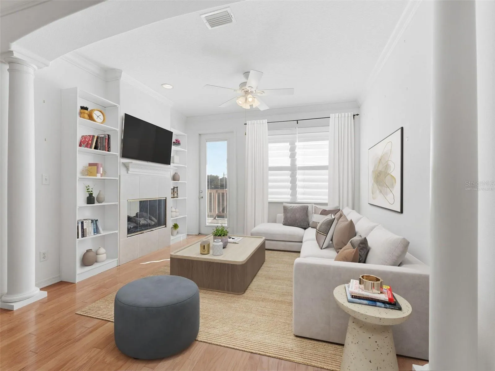 Virtually staged; bright and cozy sitting room w/fireplace leads to back deck