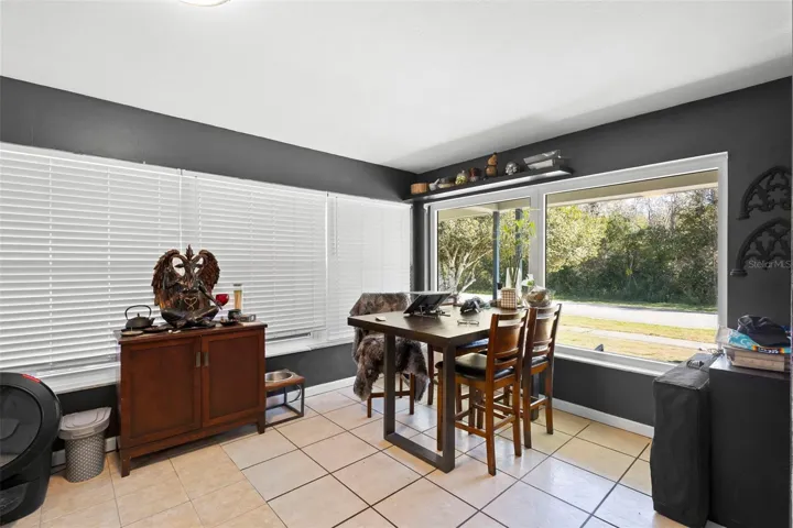 View of dining area toward front of property and entrance.