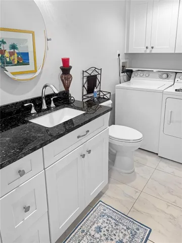 Downstairs half bathroom and full size laundry.