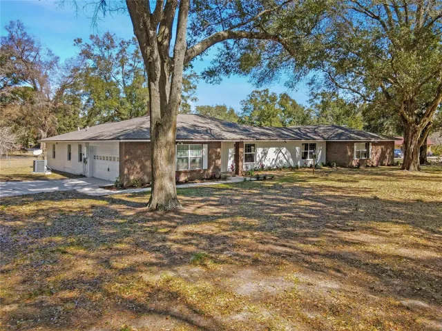 Sprawling FOUR-Bedroom, THREE-Bath, #3800 Square-Foot, Concrete-Block Estate Home with a Two-Car Garage on Over an ~ACRE OF LAND~… Shaded by Oak Trees! HOLY COW!