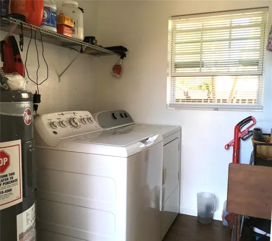 Hot water heater, washer, & dryer in laundry room just off kitchen