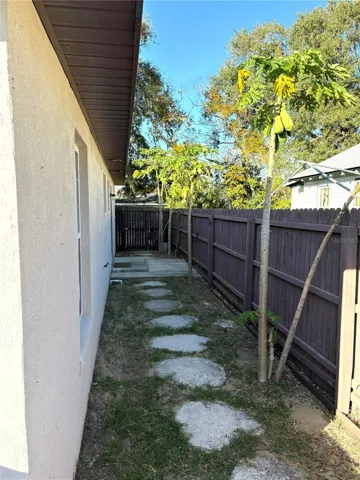 Backyard path back to patio and sliding door entrance to kitchen