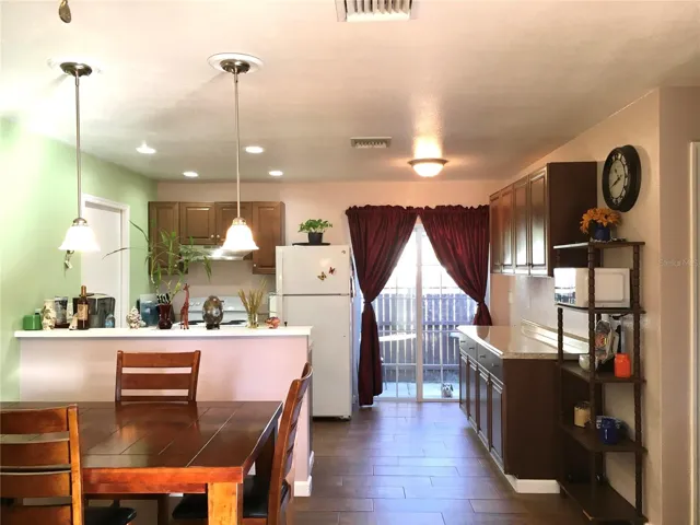 Dining room, kitchen, & sliding glass doors leading to backyard