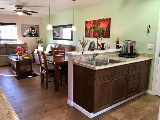 View of kitchen sink counter, dining area & living room