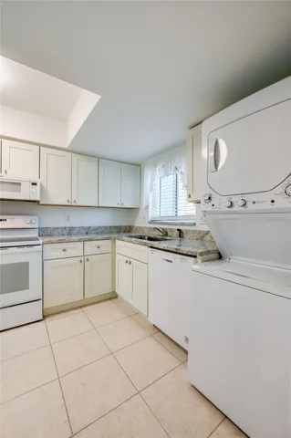 Kitchen with stack washer/dryer