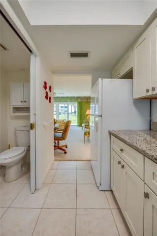 Kitchen to great room with half bath to left