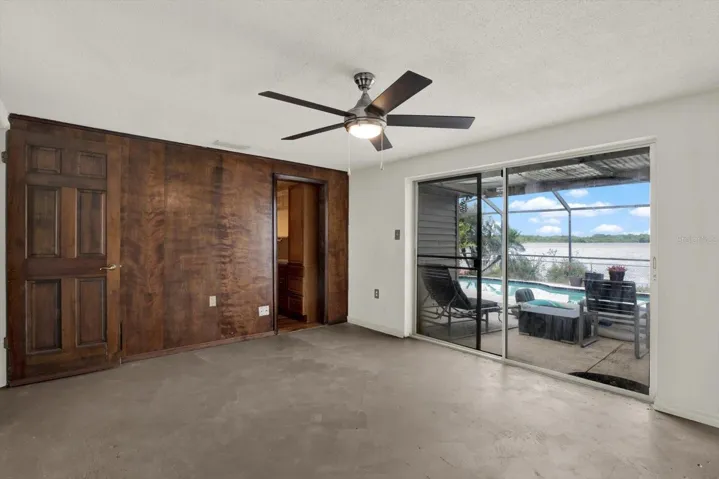 This primary suite includes a walk in closet, en suite & view to the private pool & lake