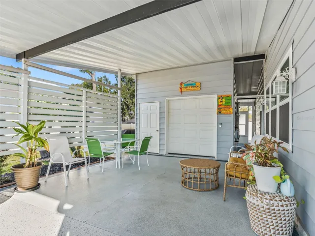 Large carport with attached 1 car garage for all your toys.