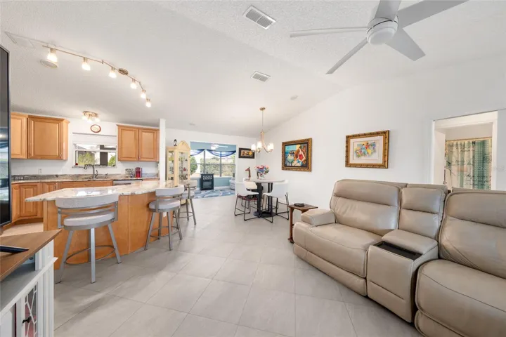 MAIN LIVING AREA - LIVING ROOM (front), KITCHEN (back L), DINING ROOM (center) & FLORIDA ROOM (back center)