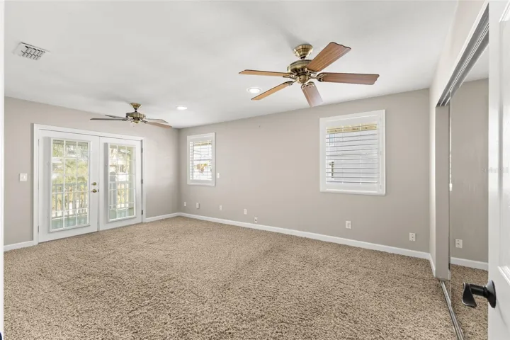 French doors off primary bedroom opens to the wrap around deck