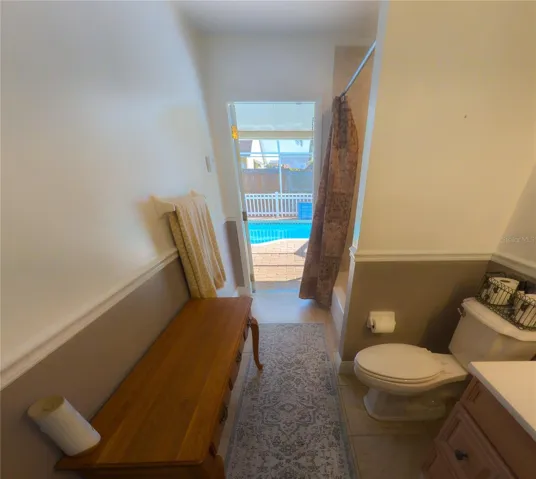 Second bathroom leads to the pool
