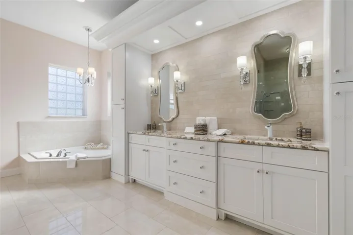 Primary en-suite bath with private commode and separate garden tub