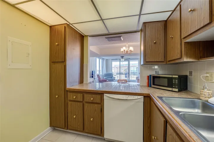 A passthrough opens to the living area, allowing for easy serving and connection to guests or family gatherings.