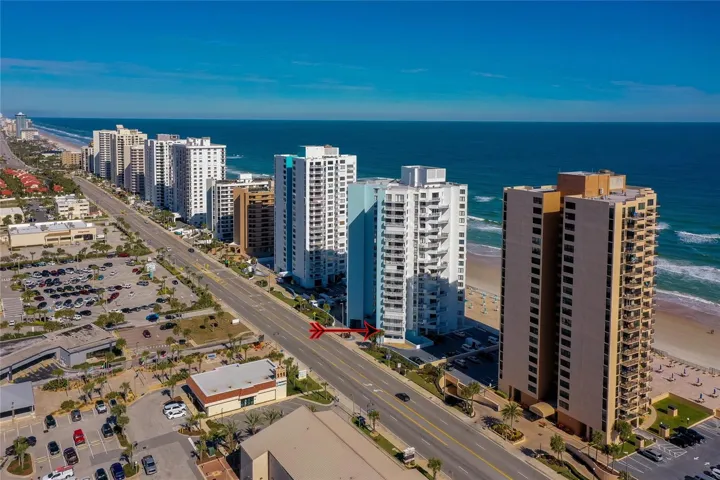 Aerial shot showing the twin towers of the complex facing the beach, highlighting ocean views and resort-style amenities.