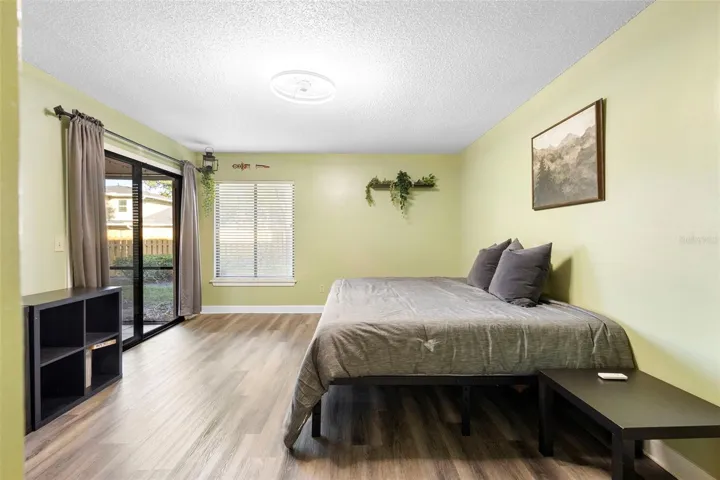 Primary Bedroom with Sliding glass doors leading onto the screened in backporch