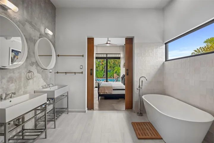 Primary Bathroom with soaking tub with sliding doors open to the pool. Includes BUILT in Desk!