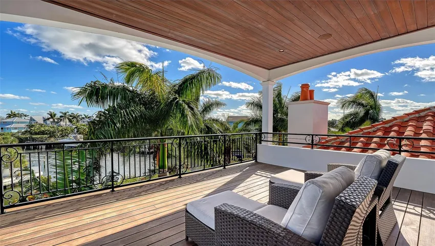 Covered terrace overlooking canal and palms