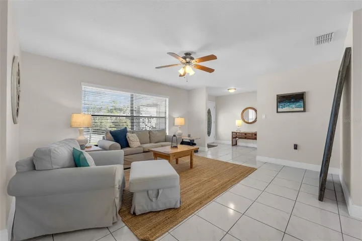 Spacious Living Room. Ceiling Fans and lots of natural lighting.