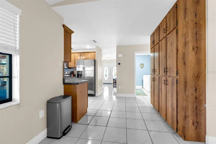 View from pantry area into laundry area and foyer. Inside Laundry room 8'2