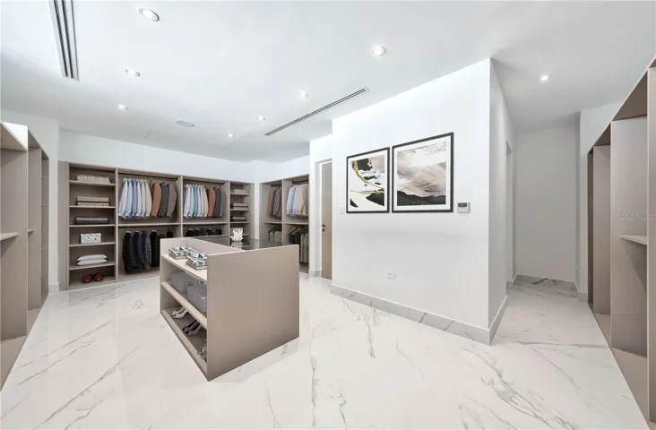 Primary Bedroom's Walk-In Closet - This image has been virtually staged and does not reflect the current state of the property.