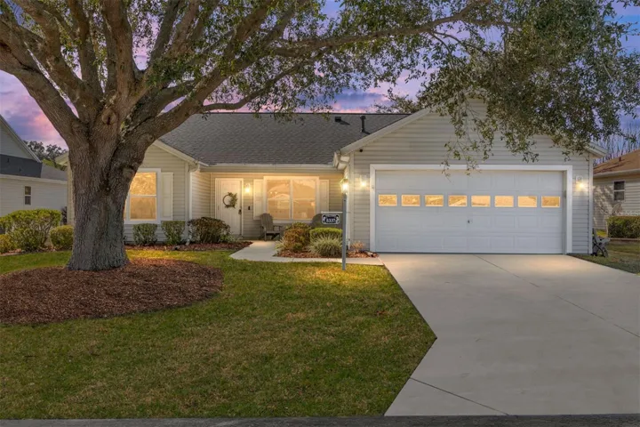 Front of House with Relaxing Shaded Sitting Area Under a Covered Patio.