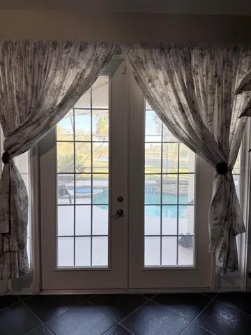 french doors from the primary room looking at the pool