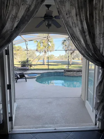 french doors open with the pool view