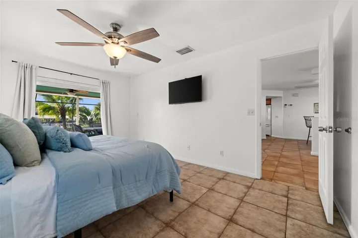 Primary Bedroom has pocketing sliders to the pool