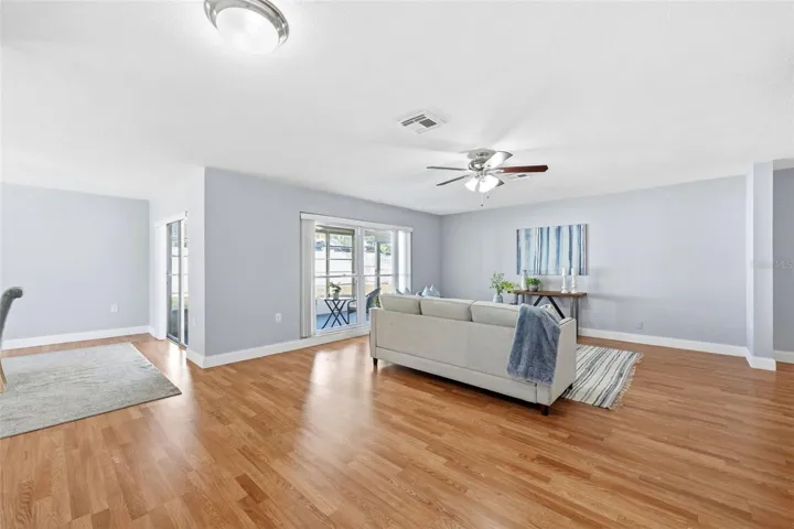 LIVING ROOM/ DINING ROOM AREA WITH ACCESS TO THE BACK YARD THROUGH FRENCH DOORS