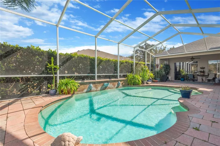 Great landscaping around pool cage for privacy