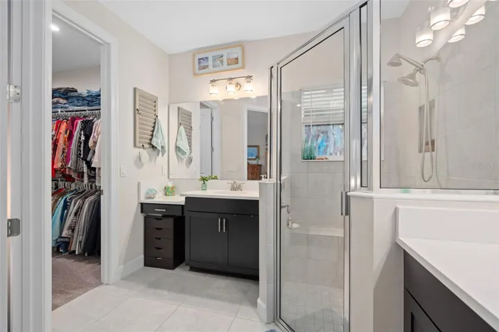Primary En-Suite offering a walk-in Shower with a Seat, Split Comfort Height Vanities, Quartz Counters, nice size Walk-in Closet and a Water Closet for your privacy.