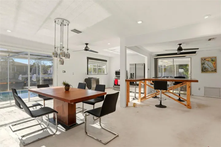 living area looks out to pool and boat dock/canal