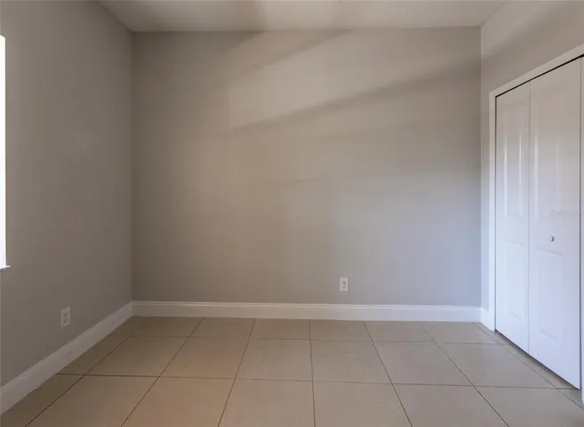 Second Bedroom NOT Staged: NO CARPETS IN THIS UNIT. Tile Throughout