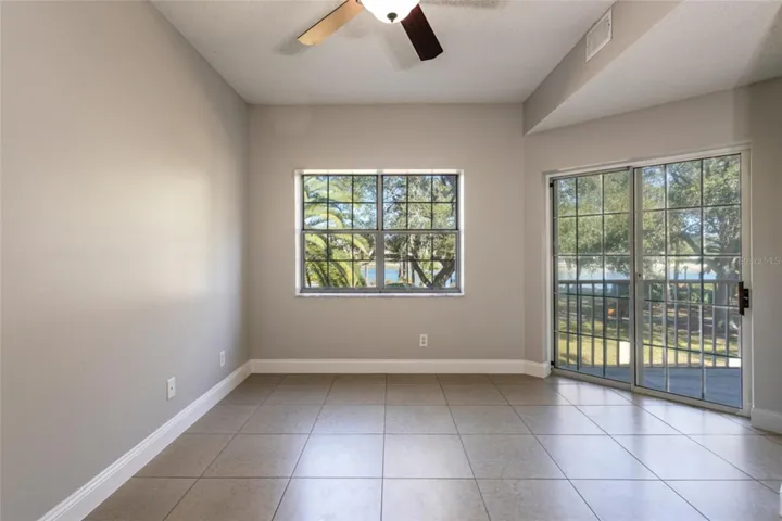 Unstaged Primary Bedroom: Lush Landscape Of Palms, Century Year Old Oaks And The Water