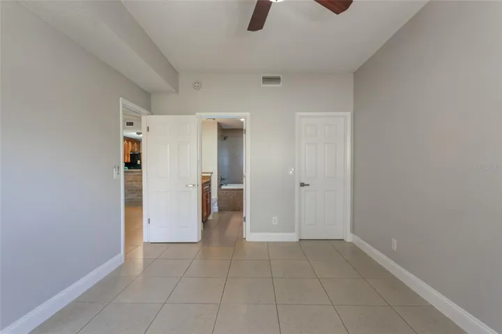Primary Bedroom With Entry Into Ensuite And Door To Walk In Closet