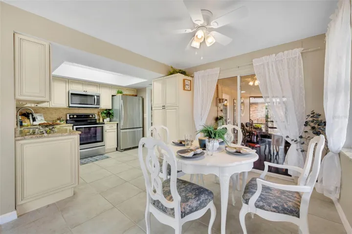 10.4 x 8 Dinette or Breakfast nook. This area has both a large window and set of sliding glass doors leading to the carpeted Lanai. New Ceiling Fan.