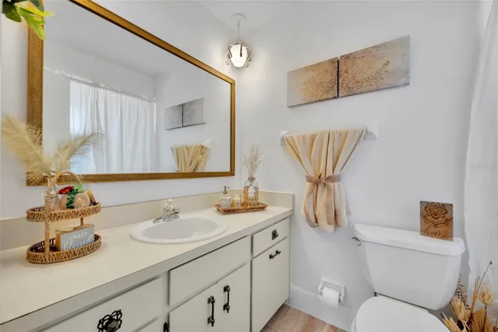 8.4 x 4.11 Primary Chic Bathroom with nicely sized vanity and mirror. Full ceramic sound shower in timeless yellow. CHECK OUT PINTEREST --