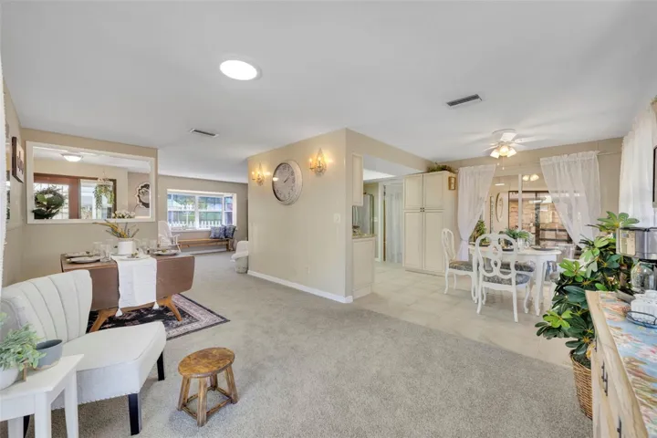 From patio sliding glass doors looking towards the dinette on right/kitchen next to it and dining room view on left.