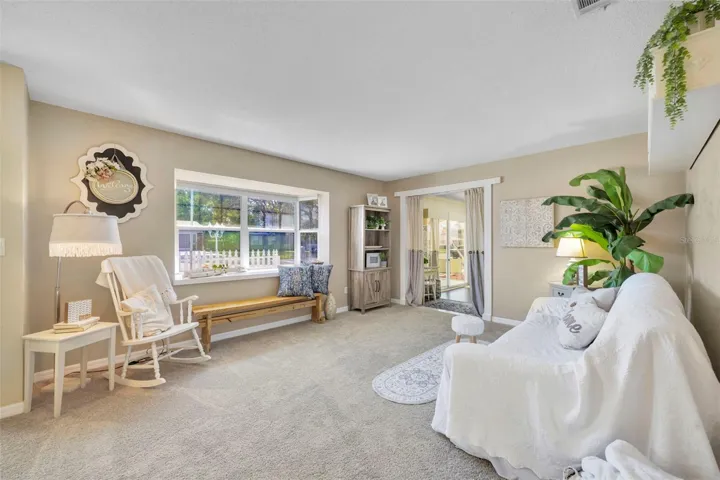 Looking into the 15.4 x 12.10 living room with view of beautiful bay window. Off to the right is entrance to great room.