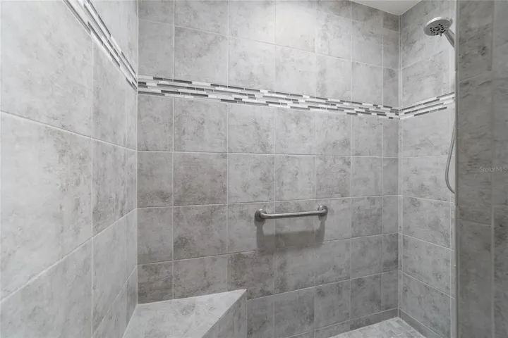 Tiled Roman shower in the primary bath
