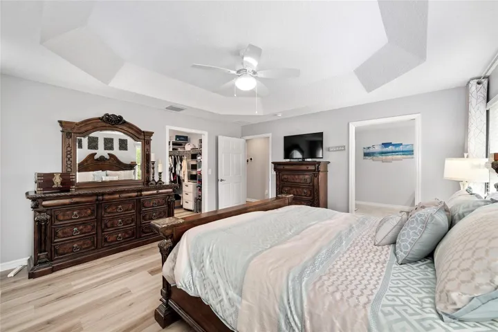 The space is elevated with a tray ceiling and overhead lighting