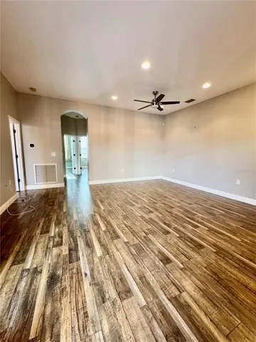Living room/dining room facing entrance to master bedroom on the left and two bedrooms on the right