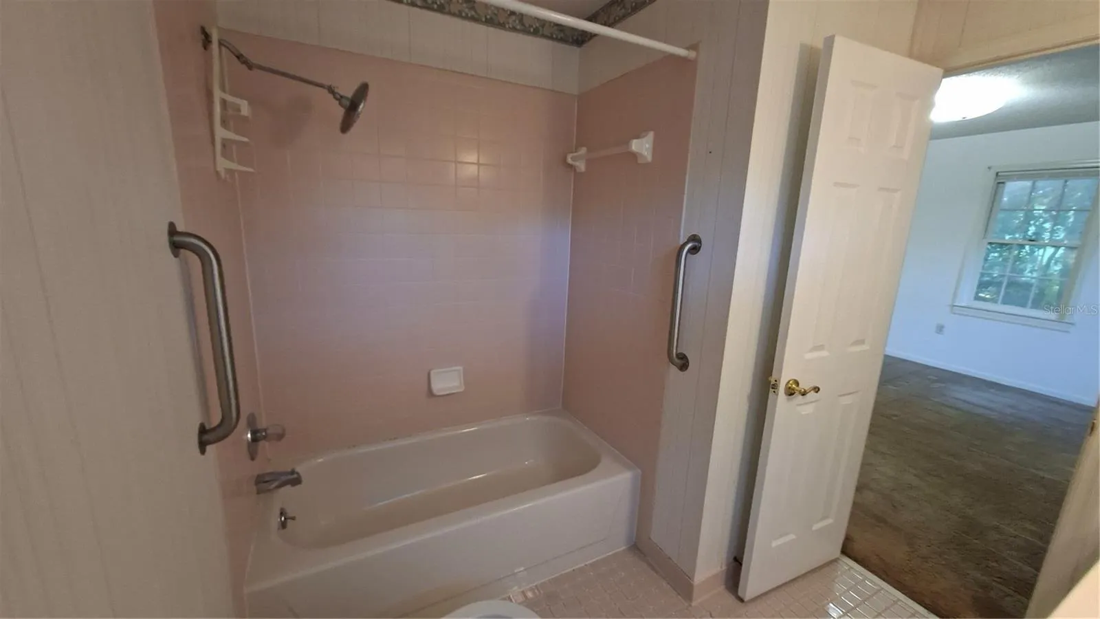 primary bathroom with view into bedroom