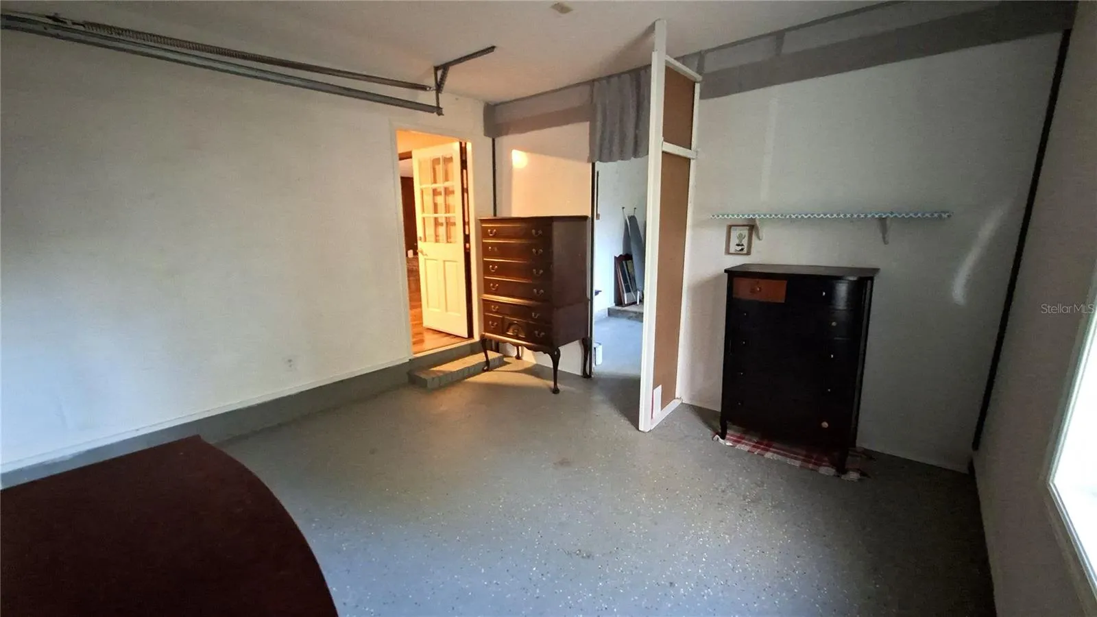 alternate view of bonus room looking into kitchen and utility room