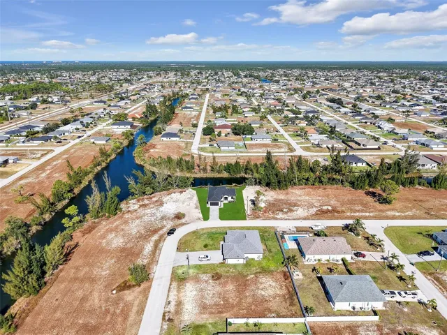 View of property location featuring nearbysuburban area and a nearby body of water