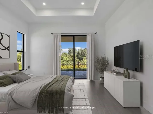Master Bedroom virtually staged - access to exterior, a raised ceiling, light wood-type flooring tile and recessed lighting