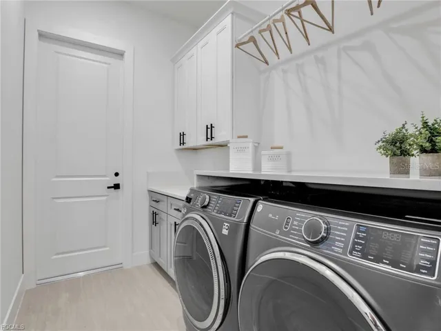 Laundry room featuring washer and dryer and cabinet space